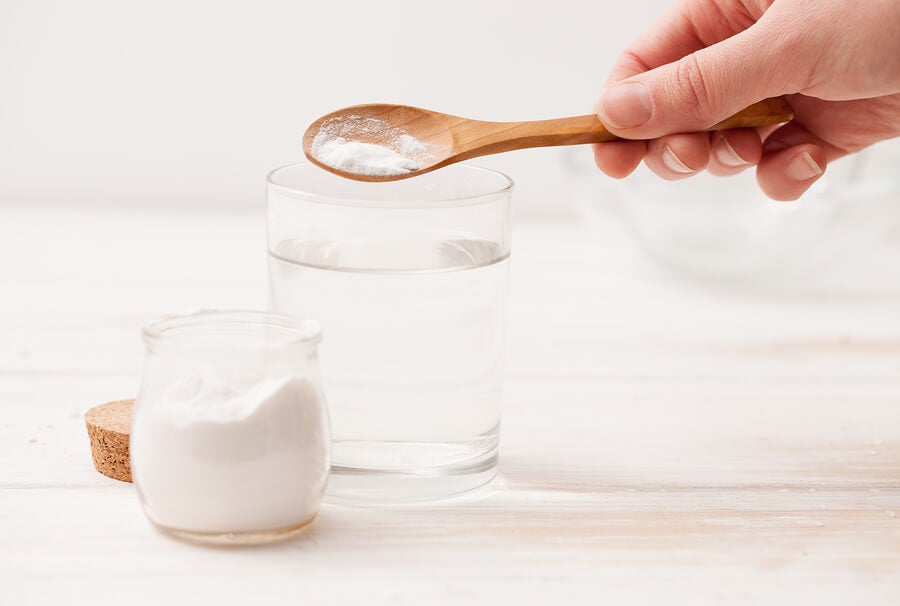 primer plano de una mano preparando bicarbonato con agua